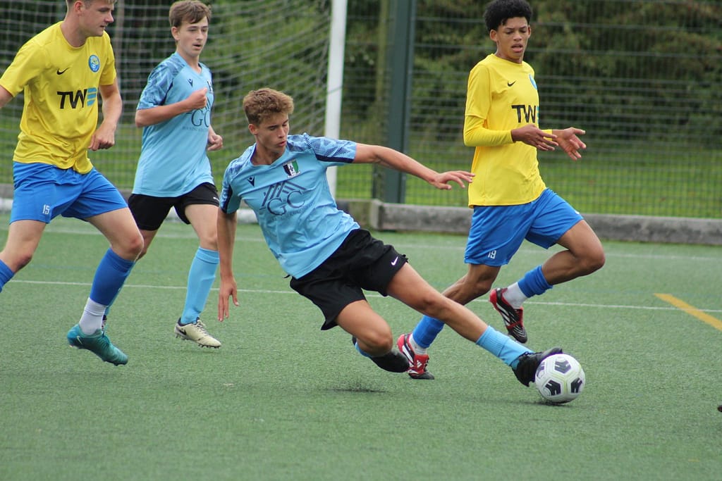 Footballer from Cray Valley U18 tacking a ball in Kings Hill, Kent